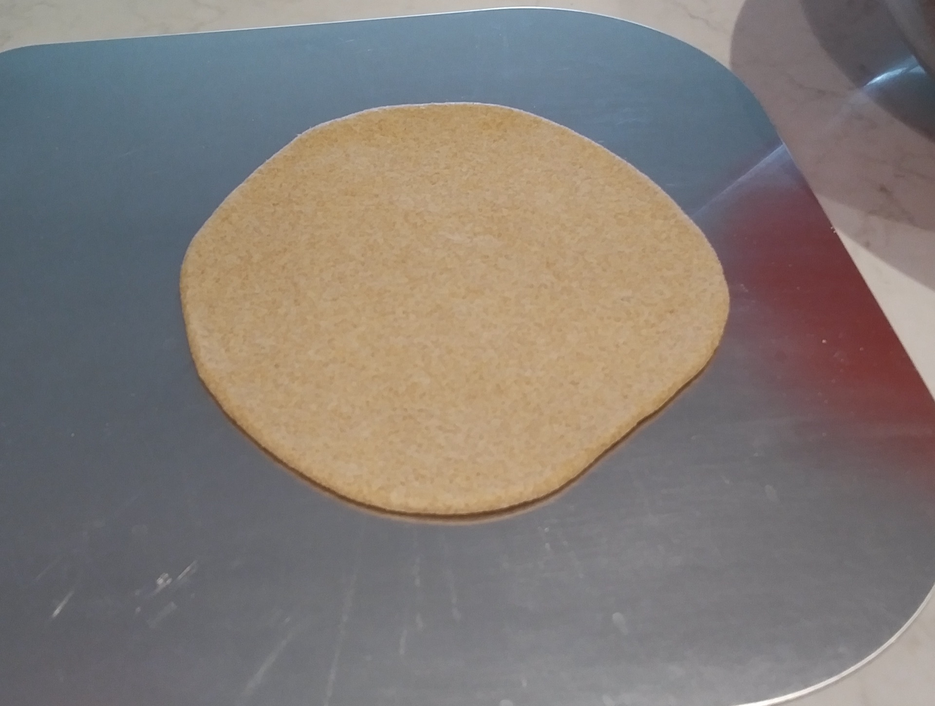 Second dough disc on peel
